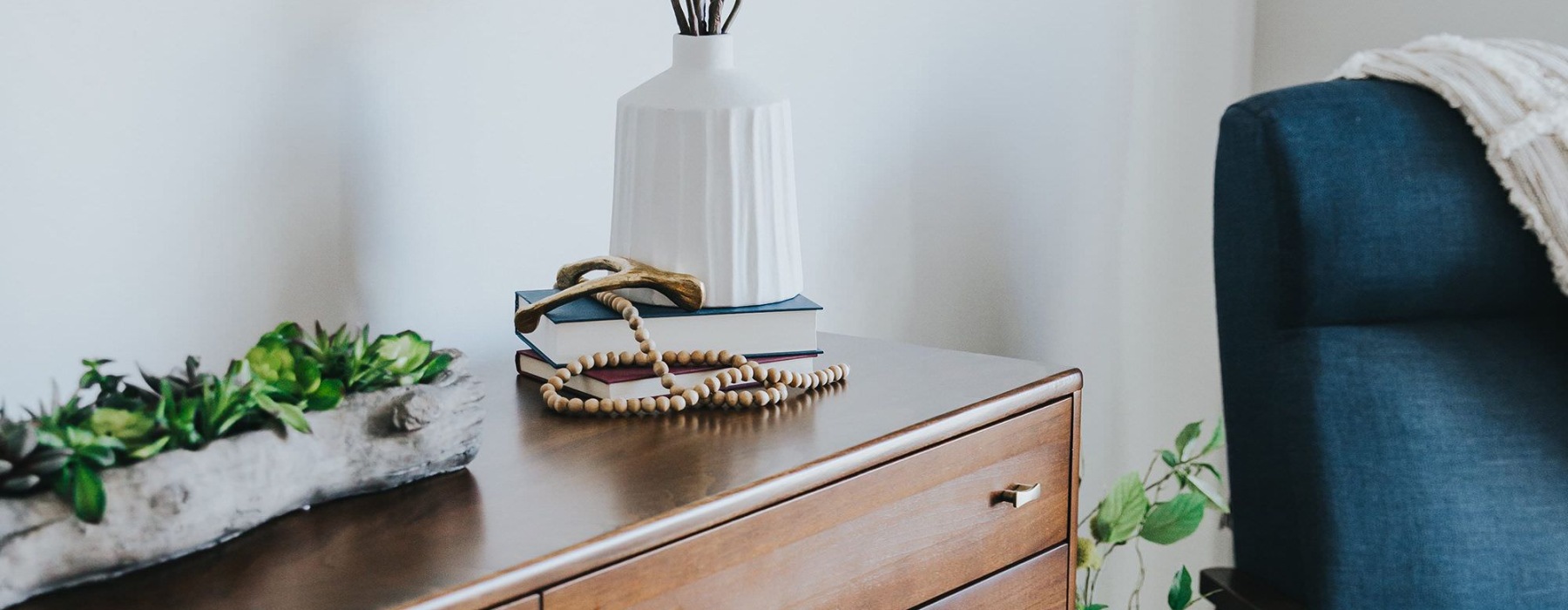 a room with a dresser and a chair